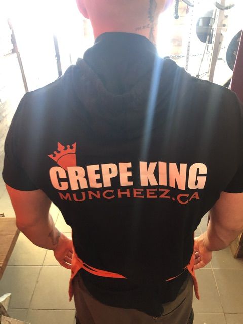 A Muncheez staff shirt reading Crepe King, muncheez.ca